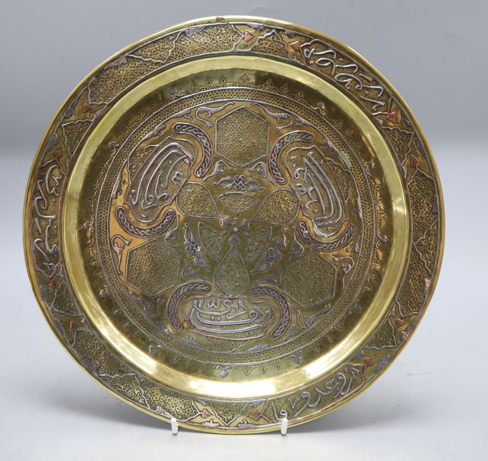 A Persian silver and copper inlaid dish, diameter 30cm